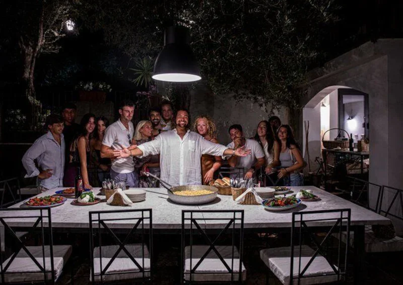 Guests gathered around a candlelit dinner table at Casa Rispo at night
