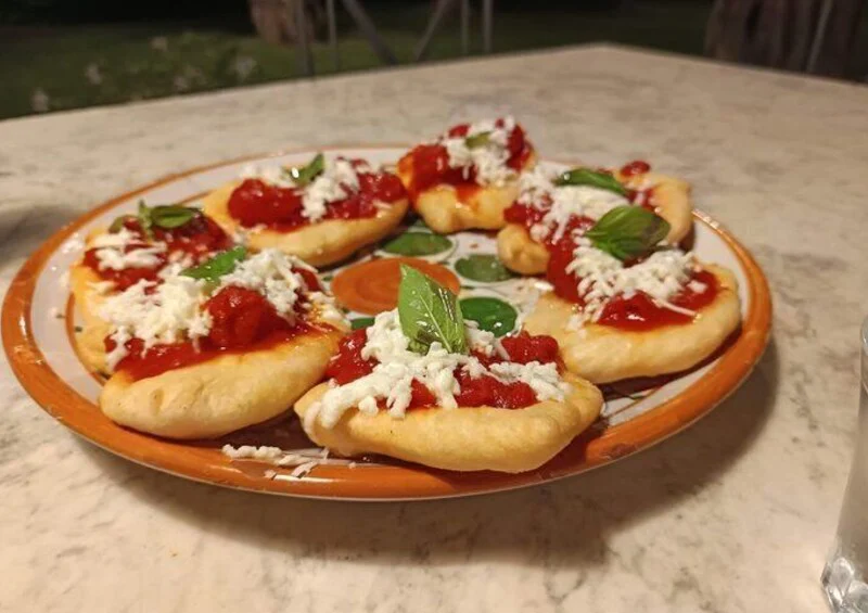 Traditional montanarine topped with tomato sauce, cheese and basil